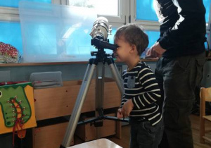 Chłopiec patrzy przez teleskop